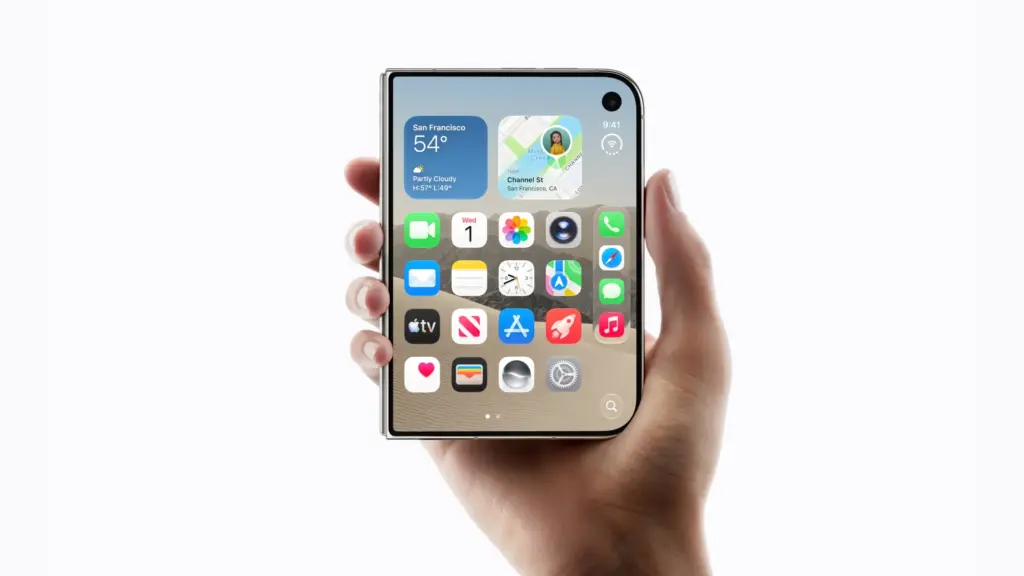 Tangan memegang iPhone Duo dalam keadaan terbuka menampilkan layar beranda iOS.