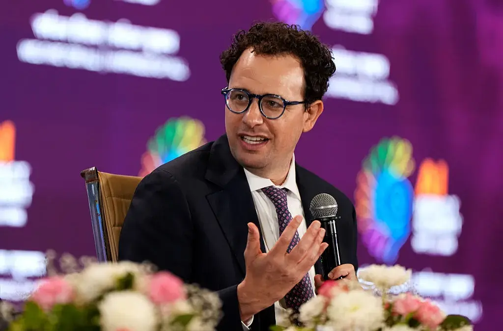 Dario Amodei, CEO Anthropic, berbicara sambil memegang mikrofon.